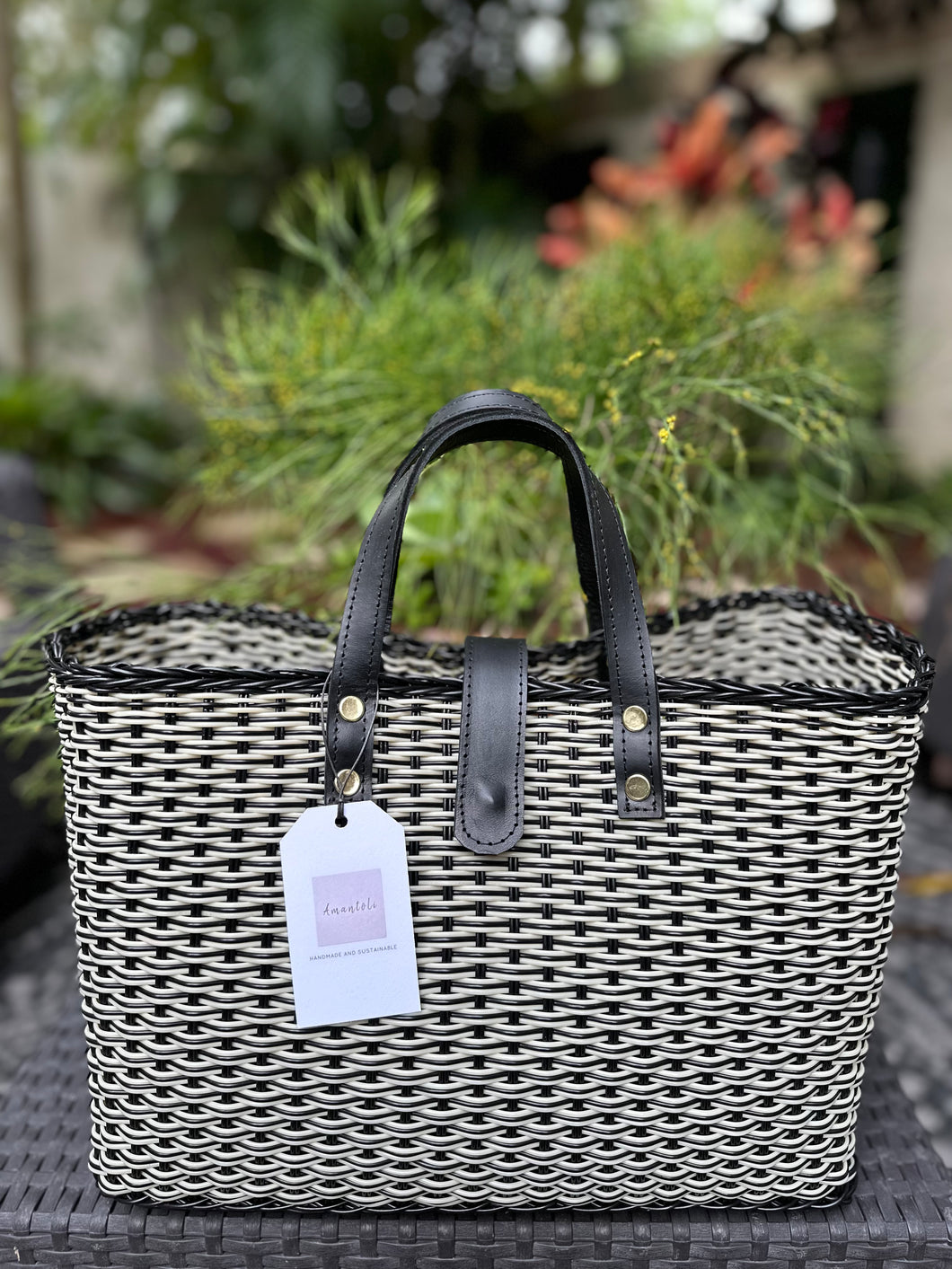 Black Triple Weave Handbag With Black Leather Handles And Magnetic Leather Strap.      Coming back soon.